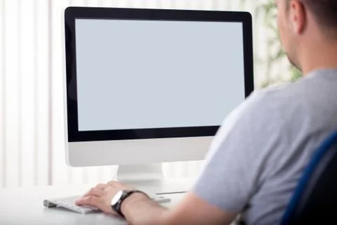 Man looks at the screen. Stock Photos