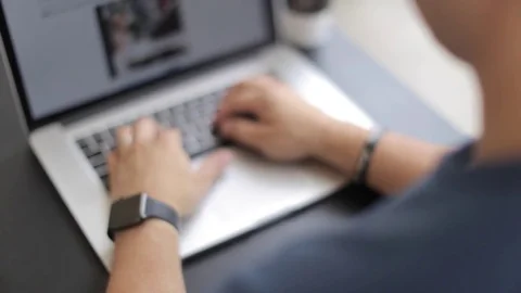 Man Looks At Smart Watch While Typing Stock Footage