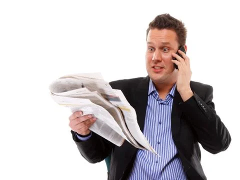 Man looks surprised while reading a newspaper Stock Photos