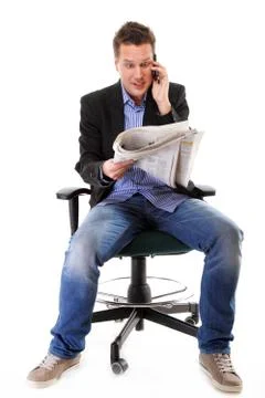 Man looks surprised while reading a newspaper Stock Photos