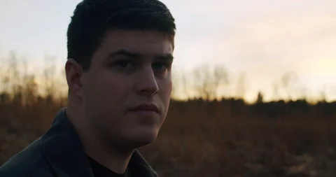 Man looks In Thought Standing in front of Sunset Stock Footage 122221427