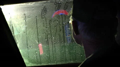 A man looks through a boat window as the rain falls. Stock Footage 46577192