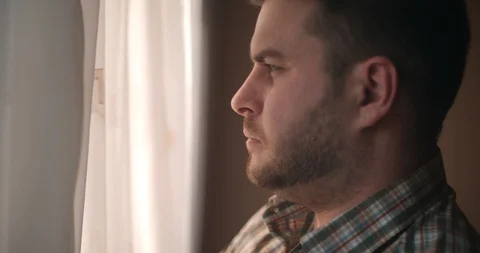 A man looks through a window in the sun Stock Footage 88730689