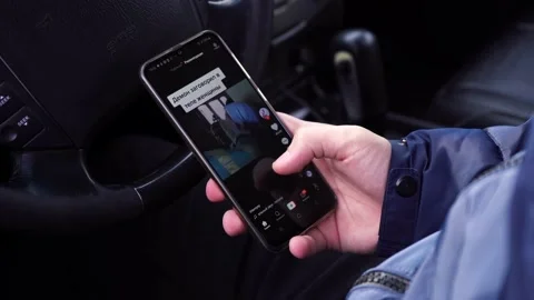 Man looks tik tok while sitting in the car. moscow russia 11 april 2021 Vídeo Stock 152134258