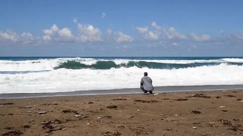 Man looks at the waves of the sea Stock-Footage 63341396