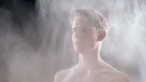 A man loses his clothes due to a sudden shock wave with a lot of dust and smoke 스톡 동영상 74438174