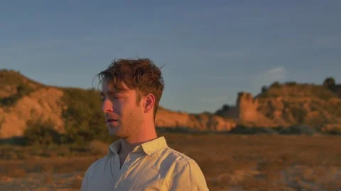 A man lost in the desert seeks his way at sunset, in Spain Stock Footage 208806641