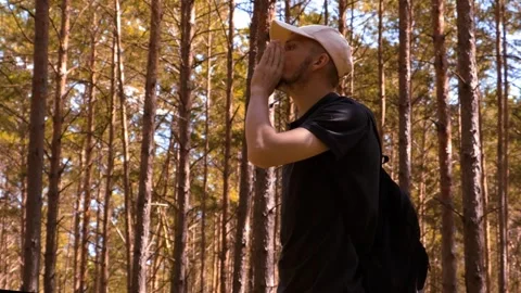 A man is lost in the forest and calls for help. Stock Footage 287762000