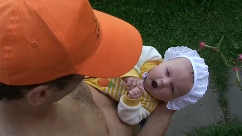 Man lovingly cradles and plays infant baby on hands. Stock Footage 69825998