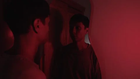 Man lowering his head before looking at his reflection and sighing, expressing Video stock 347299226