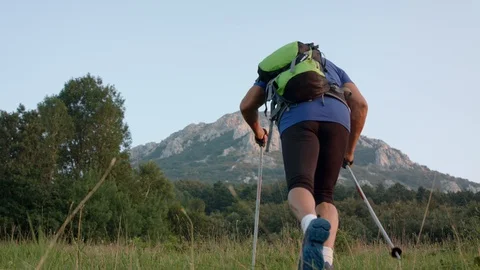 Man On The Lowland Below The Mountain, Starts His Journey To The Top Stock Footage 93661004