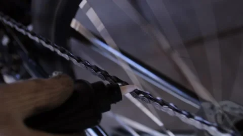 A man lubricates a bicycle chain Stock Footage 155056835