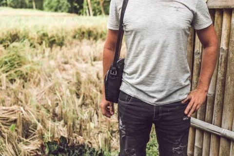 Man with luxury snakeskin python leather handbag. Bali island background. Foto stock