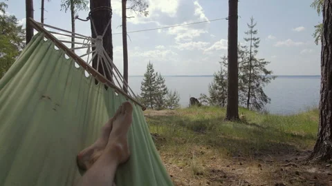 Man Lying And Swinging On Hammock Near The Sea Video stock 93236336