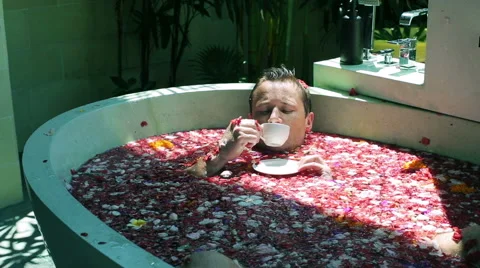 Man lying in the bath and drinking coffee Stock Footage 40331676