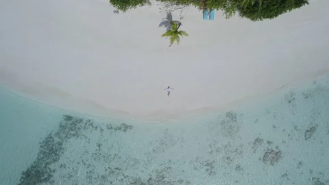 A man is lying on the beach, the camera rises up Stock Footage 243557306