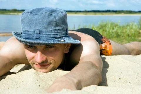 Man lying on a beach Stock Photos