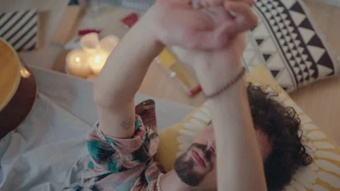 Man Lying on Bed and Looking at His Palms Stock-Footage 235658582