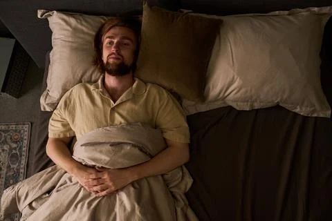 Man Lying in Bed Awake Dealing with Insomnia and Sleep Disorder Stock Photos