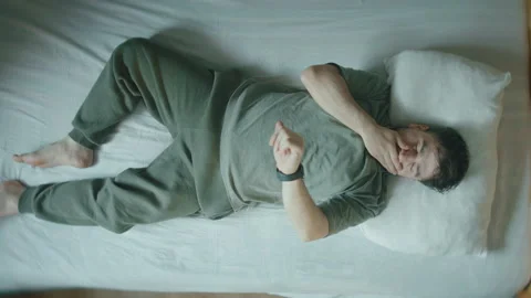 Man Lying in Bed Checking Smartwatch at Night, Insomnia and Sleep Disorder .. Stock Footage 344097680