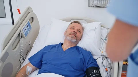 Man lying in bed at hospital Stock Footage 121505232