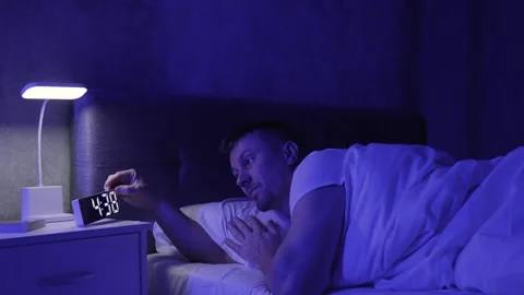 Man lying in bed at night, syndrome sleepiness, and insomnia Stock Footage 290308574