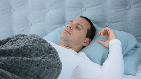 Man Lying in Bed Sleeping Deeply and Relaxed Video stock 113223086