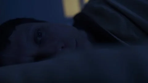 Man lying in bed suffering from insomnia night, sleepless bed and sleep Video stock 320187029