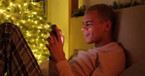 Man lying on bed using mobile phone Video stock 145294713