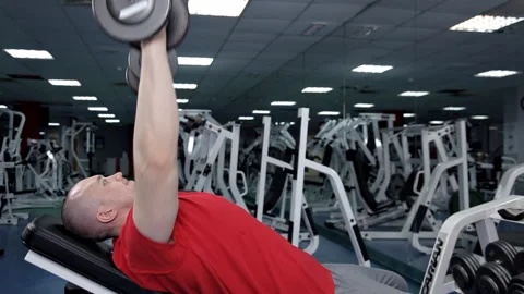 Man Lying On Bench Press While Exercising With Dumbbell Stock Footage 106736235