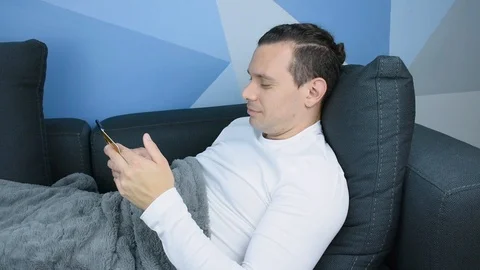 Man Lying on the Couch Buying with his Credit Card and his Phone Video stock 113223087