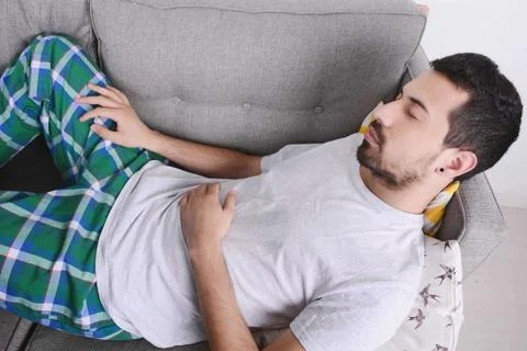 Man lying on couch. Stock Photos