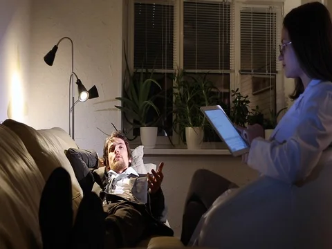 Man lying on couch at reception of the psychologist women with the tablet Stock Footage 81455738