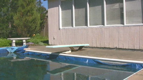 Man lying on diving board staring into water Stock Footage 545089