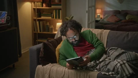 Man Lying down and Using Tablet Computer for Digital Entertainment Vídeo Stock 341680846