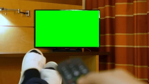 Man lying down bed relaxing on the bed watching green screen TV Stock Footage 89675153