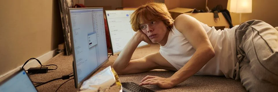 Man Lying on Floor Developing Software on Computer Screens Stock Photos