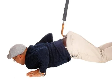 Man lying on floor pulled up with umbrella. Stock Photos