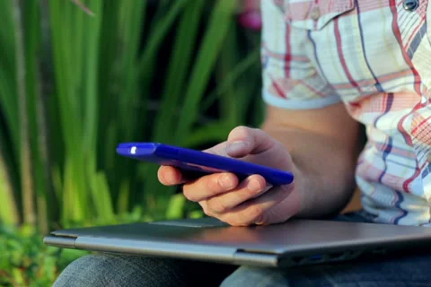 Man lying on grass in the garden and talking on cellphone Stock-Footage 39808558