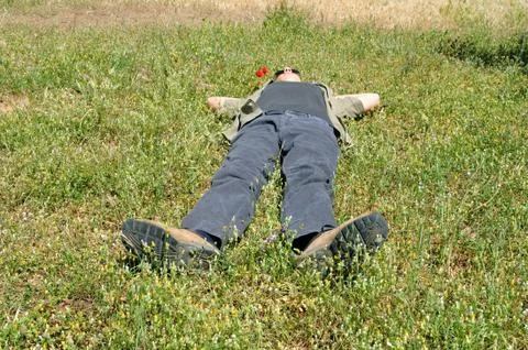 Man lying on grass Stock Photos