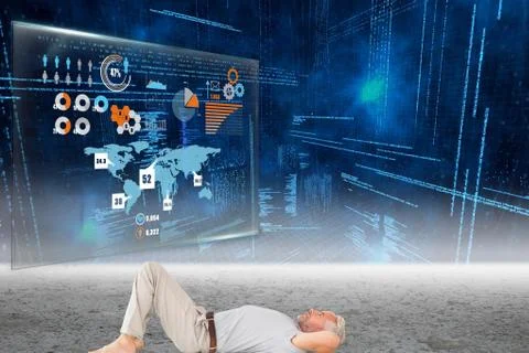 Man lying on ground in front of data and graphs 스톡 사진