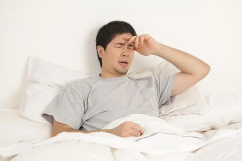 Man lying with headache Stock Photos
