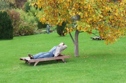A man, lying on a lounger Stock Photos