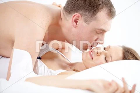 A man lying over his girlfriend and stroking her Stock Photos