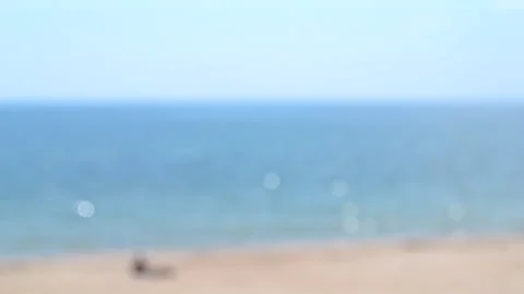 Man lying resting sunbathing sandy beach sea shore calm blue white bokeh spots Stock Footage 248508168