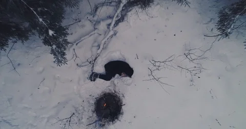 A man lying in the snow, aerial Stock Footage 104497337