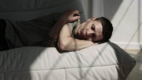 Man lying on sofa in despair, fatigue and anxiety mood. Burnout and stress Stock Footage 311763074