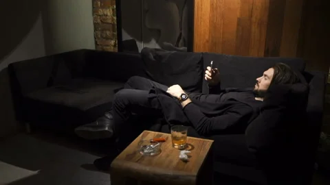 Man is lying on the sofa Stock Footage 86258193