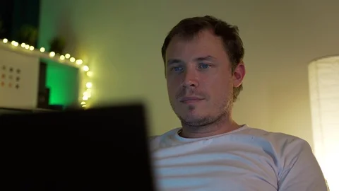 Man lying on sofa with laptop Stock Footage 129117639