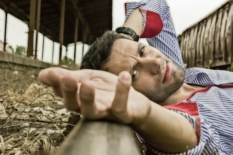 Man lying on the tracks and posing Stock Photos